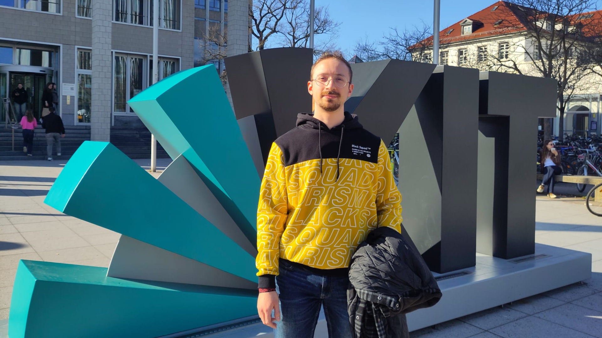 Marco Demartino poses in front of the KIT Photopoint for a picture.